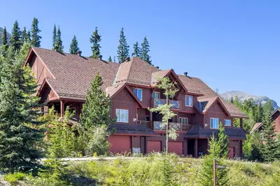 a large house in the woods with trees at Whispering Pines 3BR Townhouse Views and private Hot Tub in Golden