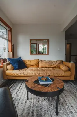 a living room with a couch and a coffee table at Chesterman on the Point - Beachfront in Tofino