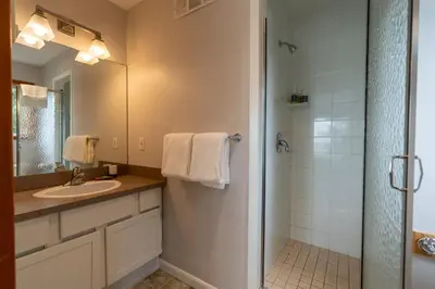 a bathroom with a sink and a shower at Chesterman on the Point - Beachfront in Tofino