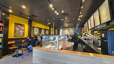a restaurant with a counter and people sitting at tables at Sunny 1BR Detached Suite - Near City Center in Vancouver