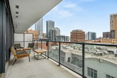 a balcony with a view of a city skyline at The Domain Skyline View King Beds Pool Gym in Calgary