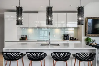 a kitchen with a sink and four bar chairs at Manhattan Right Next to Stampede Grounds DT in Calgary