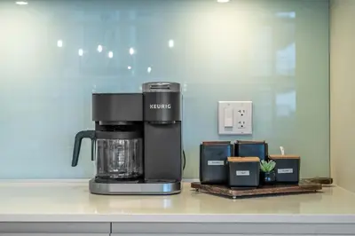 a coffee maker sitting on top of a counter at Manhattan Right Next to Stampede Grounds DT in Calgary