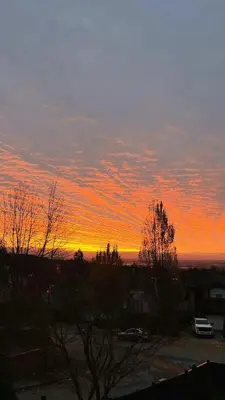 a sunset with a car parked in a parking lot at Warm house1 in Coquitlam