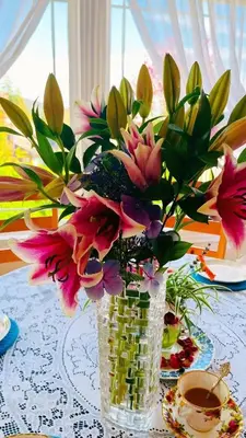 a vase filled with flowers sitting on a table at Warm house1 in Coquitlam