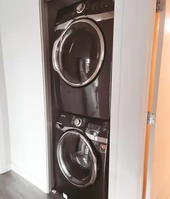 a washer and dryer in a small room at Riverside Mint 2bd den 2 ba in Calgary