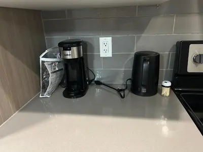 a coffeemaker and a coffee maker on a counter at Family friendly home at Chappelle garden in Edmonton
