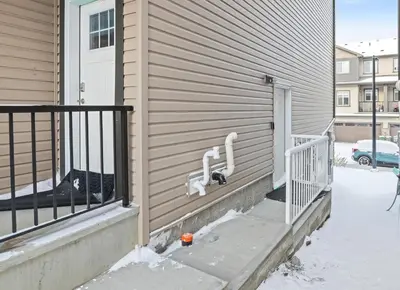 a cat is sitting on the side of a house at Laurel 27BnB in Edmonton