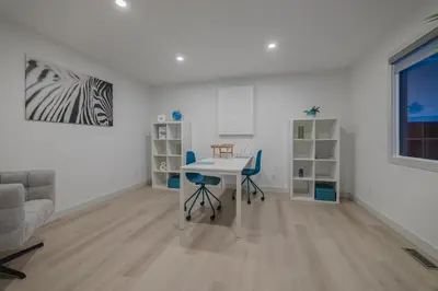 a living room with a table and chairs and a couch at Board Games, King Bed, Cocoa Bar, & Firewood! in Calgary