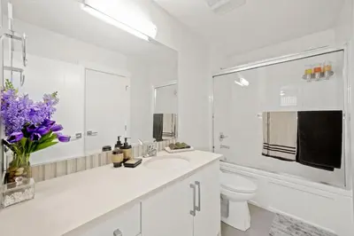 a white bathroom with a sink and a toilet at 2 bed Suburban Oasis in Surrey in Surrey