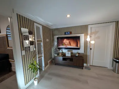 a living room with a flat screen tv on a wall at The Loft Modern in Calgary