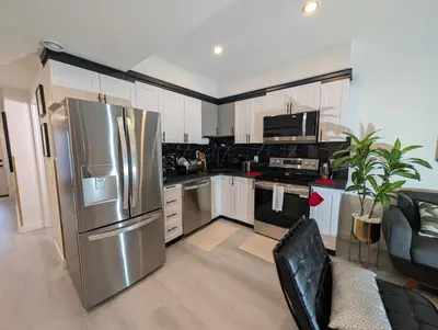 a kitchen with a stainless steel refrigerator at The Loft Modern in Calgary