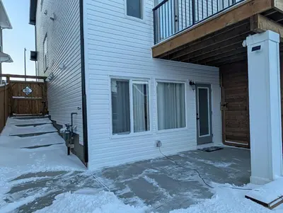 a white house with snow on the ground at The Loft Modern in Calgary
