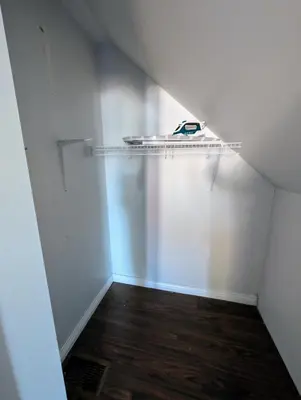 a room with a white wall and a shelf at Executive Suite 2 Bedroom Serviced Apartment in Alert Bay