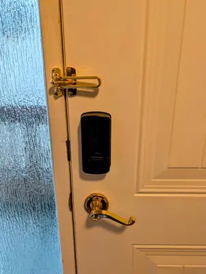 a door with a cell phone sticking out of it at Executive Suite 2 Bedroom Serviced Apartment in Alert Bay