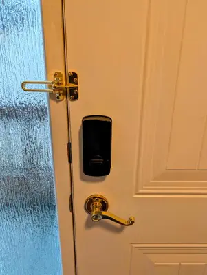 a door with a cell phone sticking out of it at Executive Suite 2 Bedroom Serviced Apartment in Alert Bay