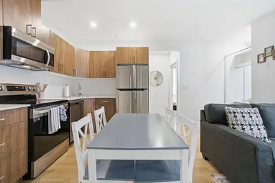 a kitchen and living room with a table and a couch at Luxury 1Beds and 2Beds in Downtown Edmonton close to Rogers in Edmonton