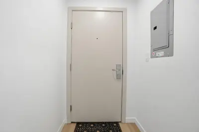 a white door with a window and a rug at Luxury 1Beds and 2Beds in Downtown Edmonton close to Rogers in Edmonton