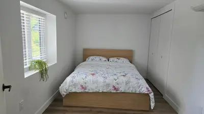 a bedroom with a bed and a window at Family Home in North Vancouver