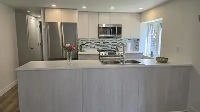 a kitchen with a sink and a counter top at Family Home in North Vancouver