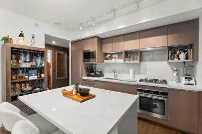 a kitchen with a white counter top in a room at Modern Chic Apartment with Balcony & Workspace in Vancouver
