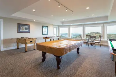 a room with a ping pong table and a table at Blue Horizon Mountain Retreat B&B in Shawnigan Lake