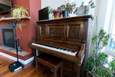 an old piano in a room with potted plants at Blue Horizon Mountain Retreat B&B in Shawnigan Lake