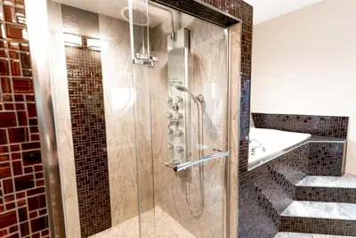 a shower with a glass door in a bathroom at Blue Horizon Mountain Retreat B&B in Shawnigan Lake