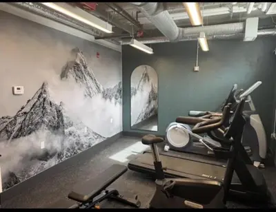 a gym with a bunch of exercise equipment on the wall at Luxury 2 Bedroom Mountain View Condo in Canmore