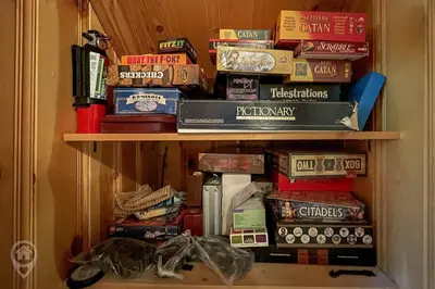 a book shelf filled with lots of books at Pet-Friendly Original Ski Cabin by StayIn in Panorama