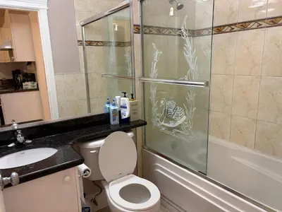a bathroom with a shower and a toilet and a sink at Vacation Home in Vancouver