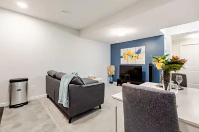 a living room with a couch and a fireplace at Cozy Suite near West Edmonton Mall & River Cree Casino in Edmonton