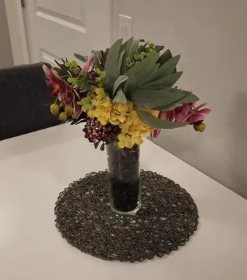a vase filled with flowers on a table at Cozy Suite near West Edmonton Mall & River Cree Casino in Edmonton