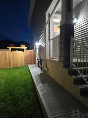 a porch of a house at night with a fence at Cozy Suite near West Edmonton Mall & River Cree Casino in Edmonton