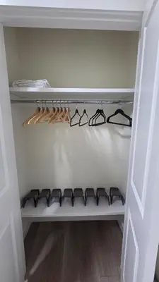 a walk in closet with glasses on a shelf at Home Away From Home With Free Netflix, Prime and Paramount in Calgary