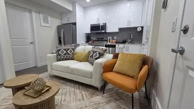 a living room with a couch and two chairs at Home Away From Home With Free Netflix, Prime and Paramount in Calgary