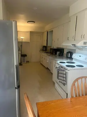 a kitchen with a white stove and a refrigerator at Vancouver Home - Airport 10 Min, Downtown 15 Min - Free Parking & Fast Wi-Fi in Vancouver