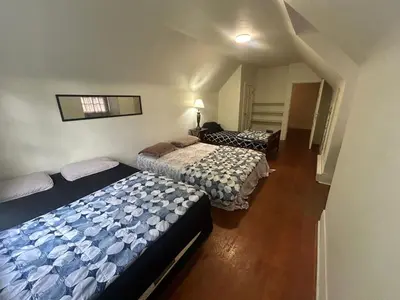 a bedroom with two beds and a hallway with stairs at Vancouver Home - Airport 10 Min, Downtown 15 Min - Free Parking & Fast Wi-Fi in Vancouver