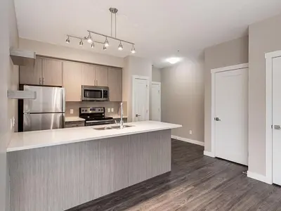 a kitchen with a counter and a stove top oven at Mdx in Edmonton
