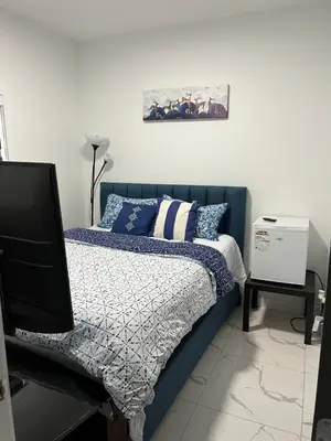 a bedroom with a bed and a picture on the wall at Private room with full washroom in Edmonton
