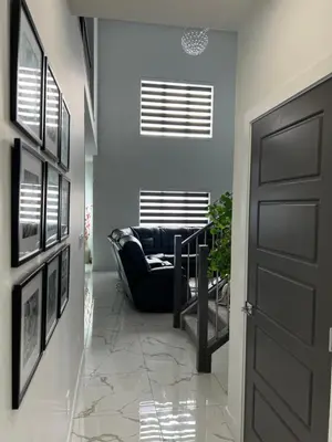 a hallway with a black door and a couch at Private room with full washroom in Edmonton