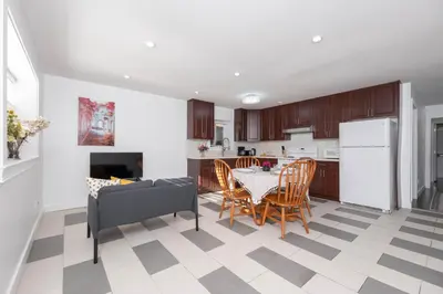 a kitchen and dining room with a table and chairs at Cozy 2B Suite in Great Location Near Trails & Shop in North Vancouver