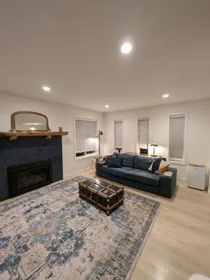 a living room with a couch and a fireplace at Colwood Hidden Home in Colwood
