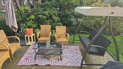 a group of chairs and a table on a patio at Bright Private Room in Echo Valley Home in Victoria