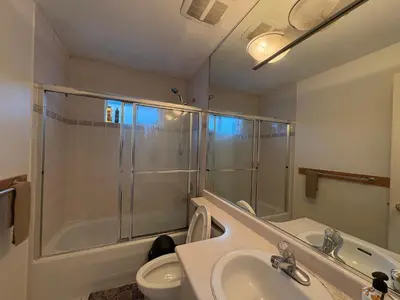 a bathroom with a shower and a sink and a toilet at Vancouver Guest House - Airport & Downtown 15 Min - Free Parking & Fast Wi-Fi in Vancouver