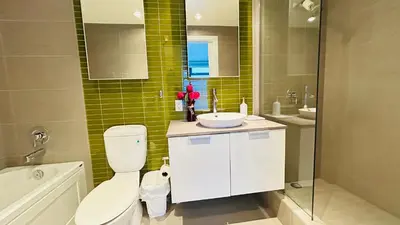 a bathroom with a toilet and a sink and a tub at Ocean and Mountain View Home - Downtown Vancouver in Vancouver