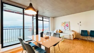 a living room with a table and chairs and a couch at Ocean and Mountain View Home - Downtown Vancouver in Vancouver