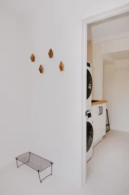 a laundry room with a table and two washing machines at Luxury 1BR at Red Mountain Ski-Bike Sauna in Rossland