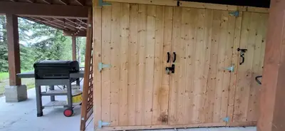 a wooden wall of a house with a grill at Luxury 1BR at Red Mountain Ski-Bike Sauna in Rossland