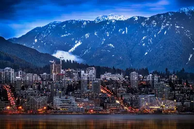 a city skyline with mountains in the background at Central Lonsdale Gem in North Vancouver